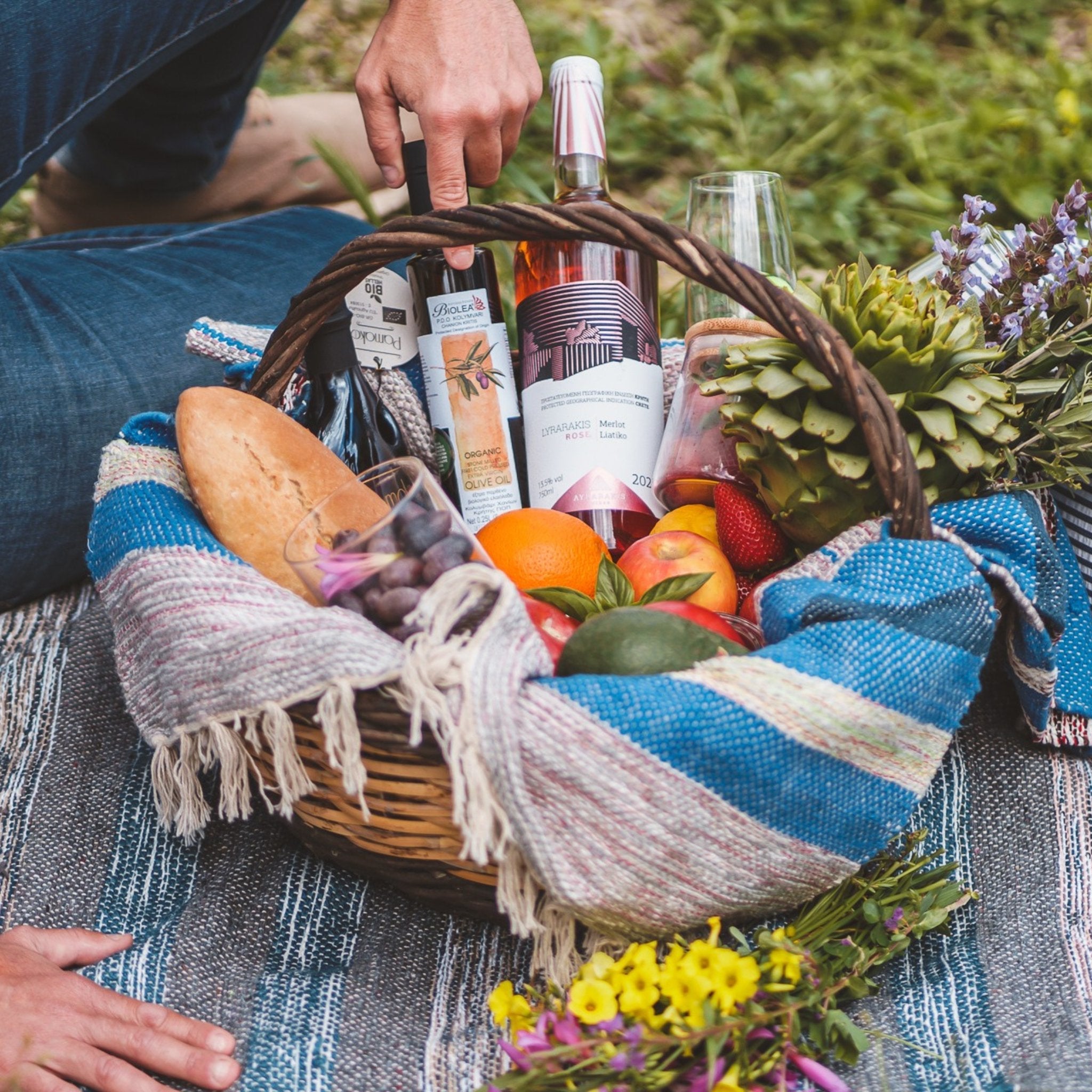 Wooden basket full of premium products including BIOLEA organic olive oil with Lemons.