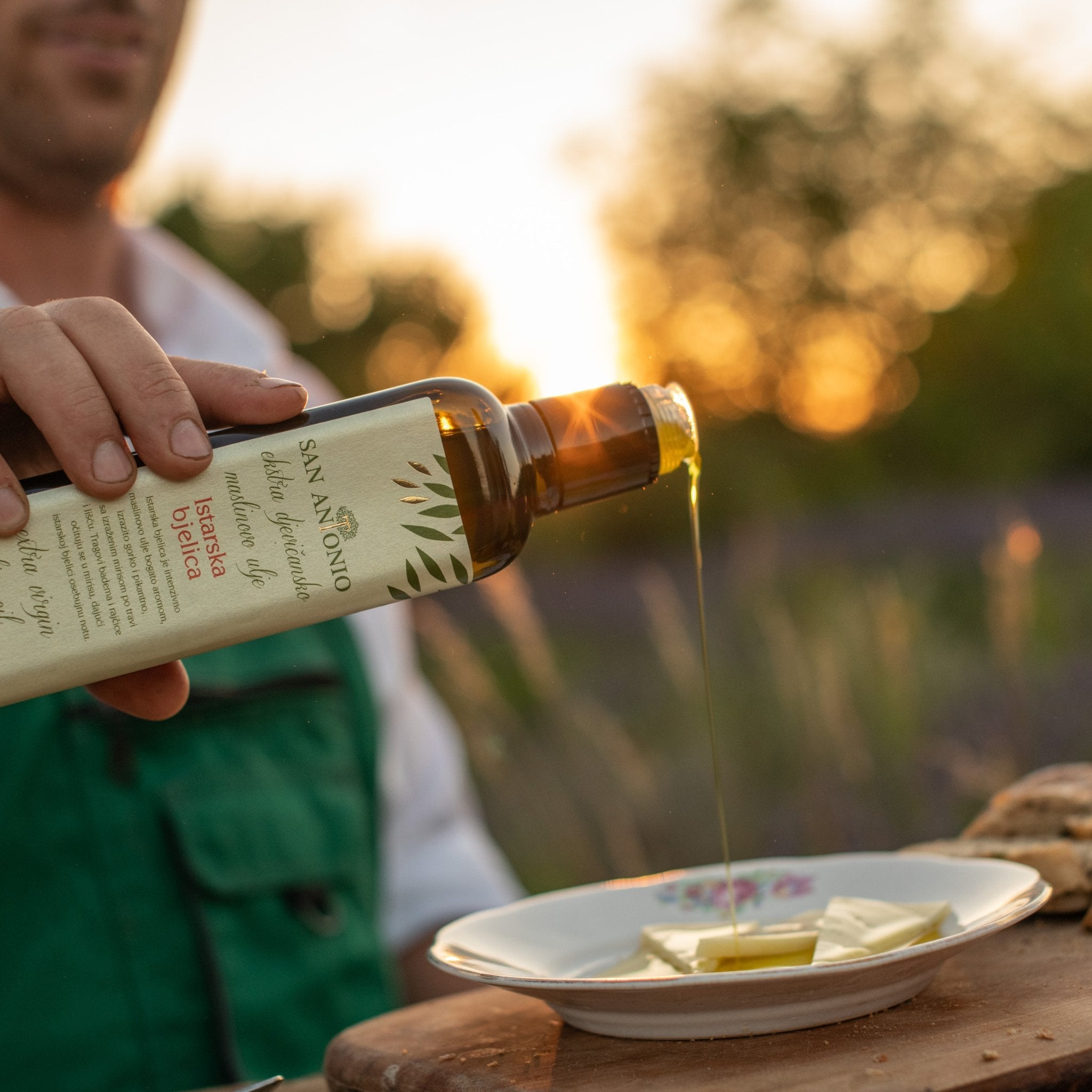 Organic Olive Oil | Istrian Bjelica EVOO from Croatia over curated cheese.