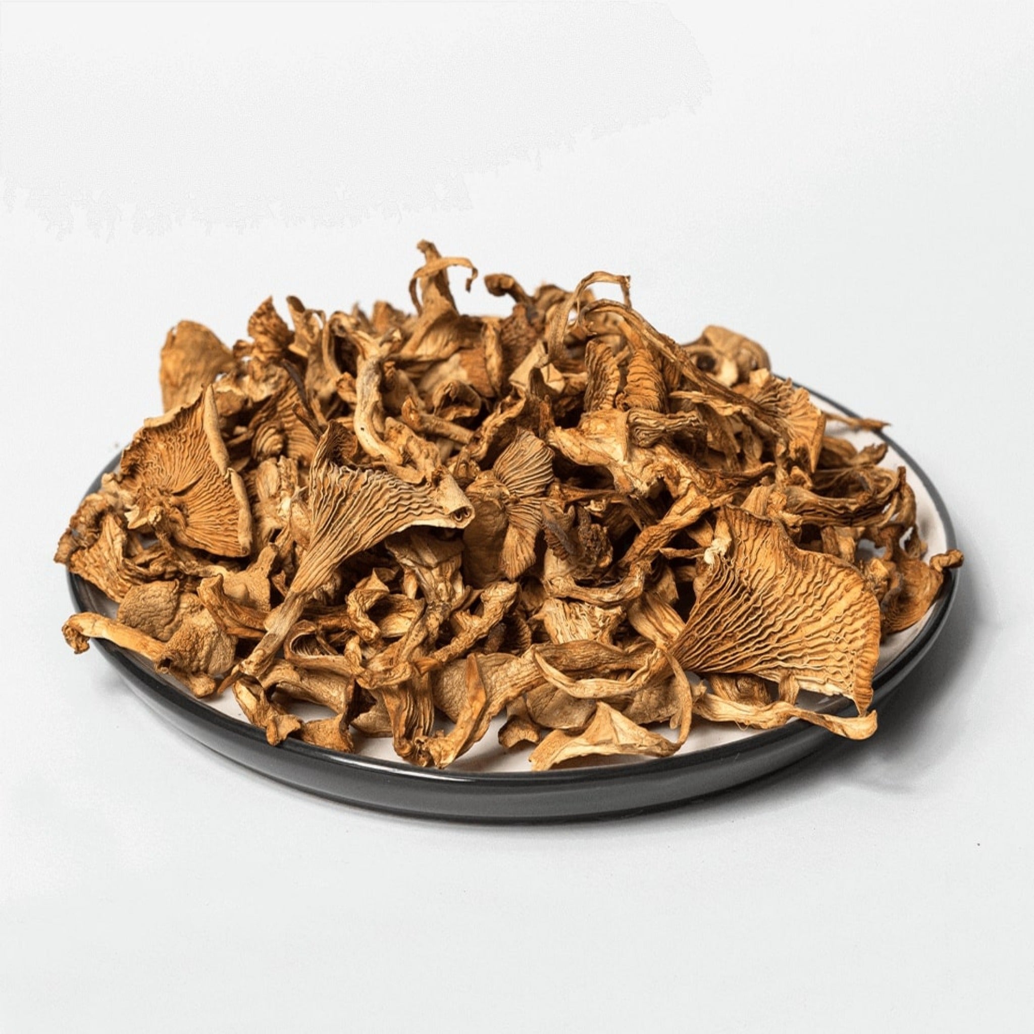 A plate full of dried chanterelles mushrooms. Shop online at The Bio Foods.