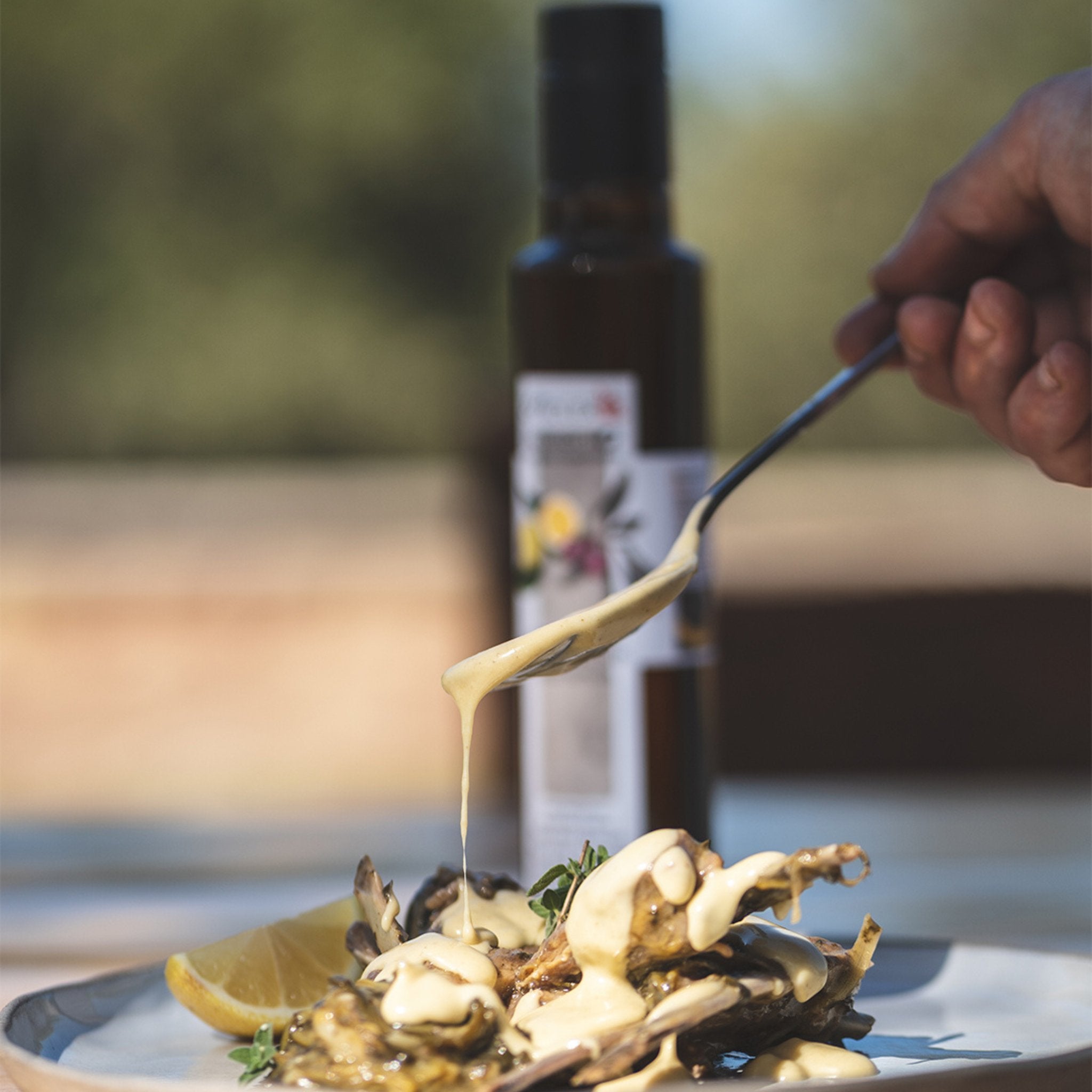 Bottle of Organic Biolea EVOO with lemons  and sauce for meet.